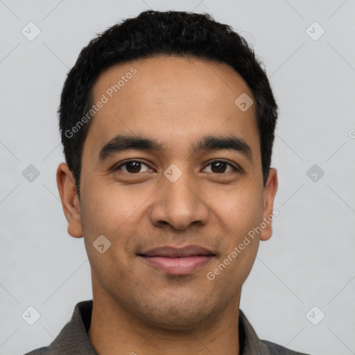 Joyful latino young-adult male with short  black hair and brown eyes