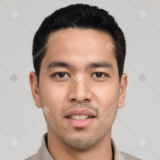 Joyful white young-adult male with short  black hair and brown eyes