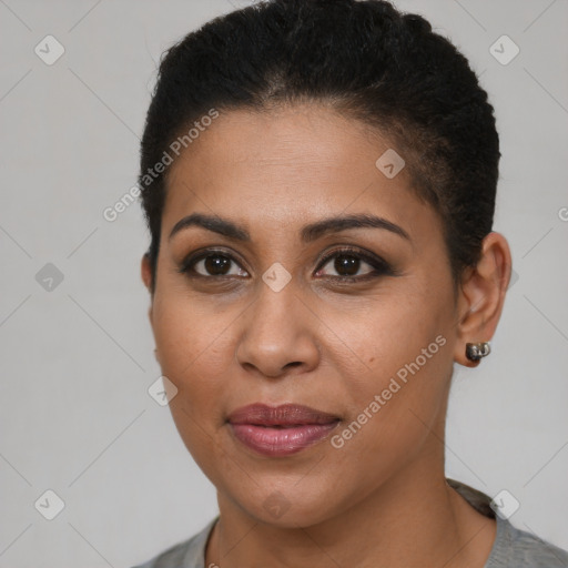 Joyful black young-adult female with short  brown hair and brown eyes