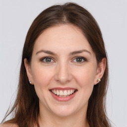 Joyful white young-adult female with long  brown hair and grey eyes