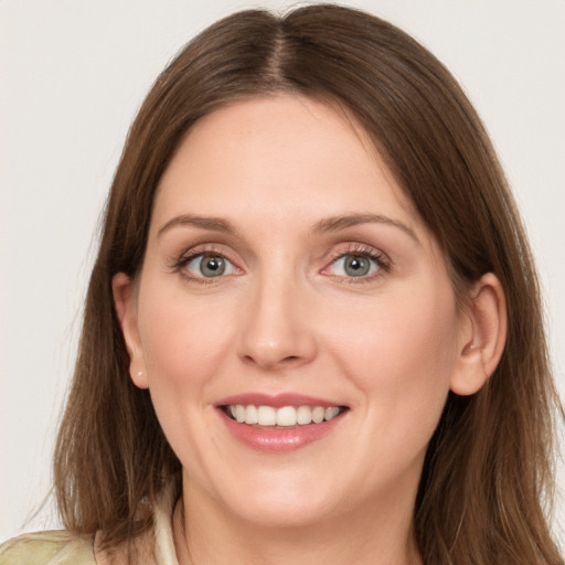 Joyful white young-adult female with long  brown hair and grey eyes