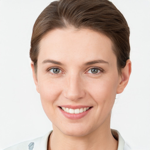 Joyful white young-adult female with short  brown hair and grey eyes