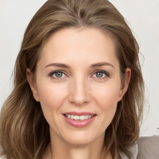 Joyful white young-adult female with medium  brown hair and grey eyes