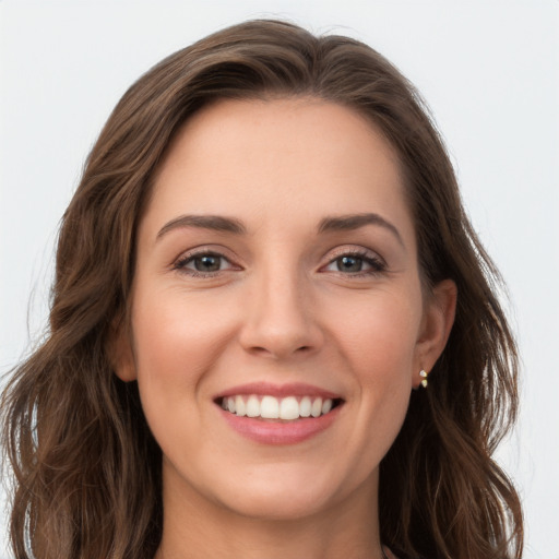 Joyful white young-adult female with long  brown hair and brown eyes