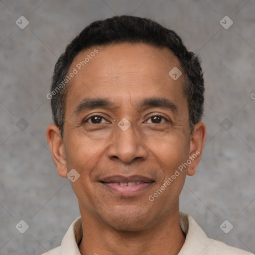 Joyful latino adult male with short  black hair and brown eyes