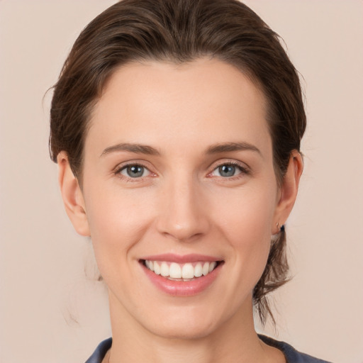 Joyful white young-adult female with short  brown hair and grey eyes