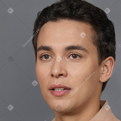 Joyful white young-adult male with short  black hair and brown eyes