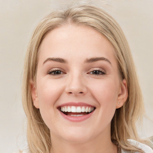 Joyful white young-adult female with medium  brown hair and blue eyes