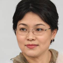 Joyful asian adult female with medium  brown hair and brown eyes