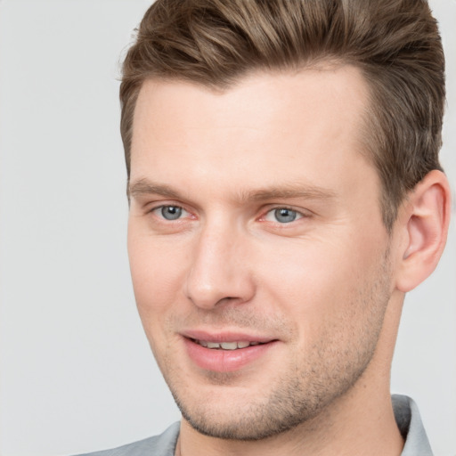 Joyful white young-adult male with short  brown hair and brown eyes