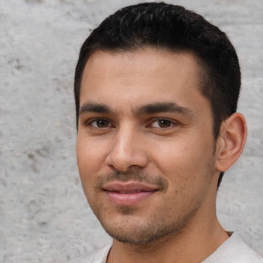 Joyful white young-adult male with short  black hair and brown eyes