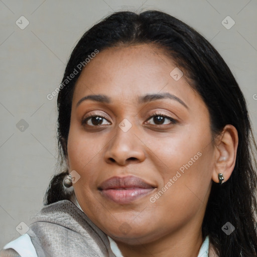 Joyful black young-adult female with long  brown hair and brown eyes