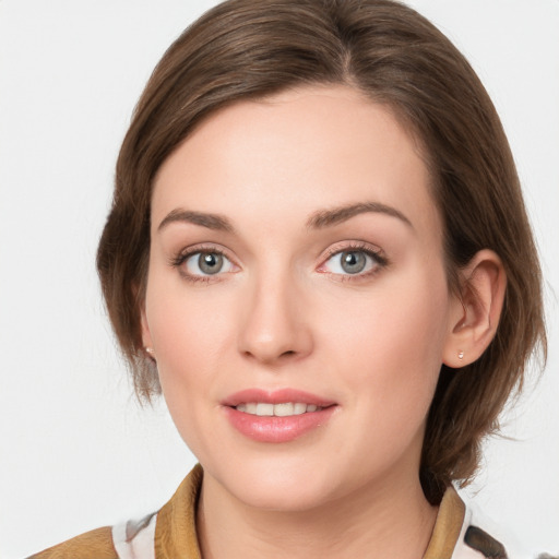 Joyful white young-adult female with medium  brown hair and blue eyes