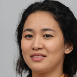 Joyful asian young-adult female with medium  brown hair and brown eyes