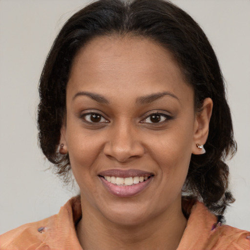 Joyful latino adult female with medium  brown hair and brown eyes