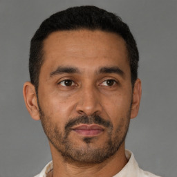 Neutral latino adult male with short  black hair and brown eyes