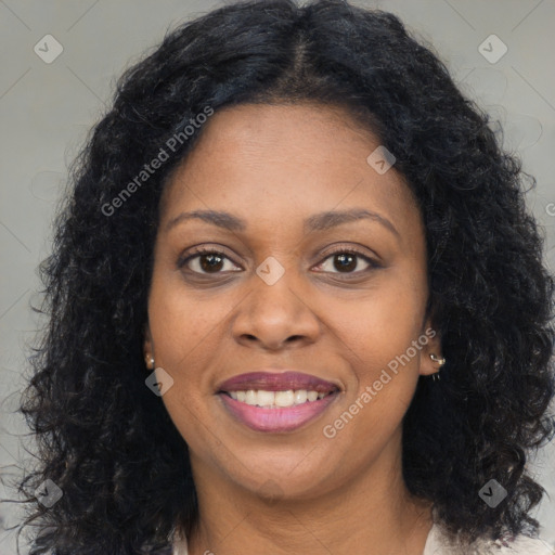 Joyful black young-adult female with long  brown hair and brown eyes