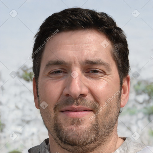 Joyful white adult male with short  brown hair and brown eyes