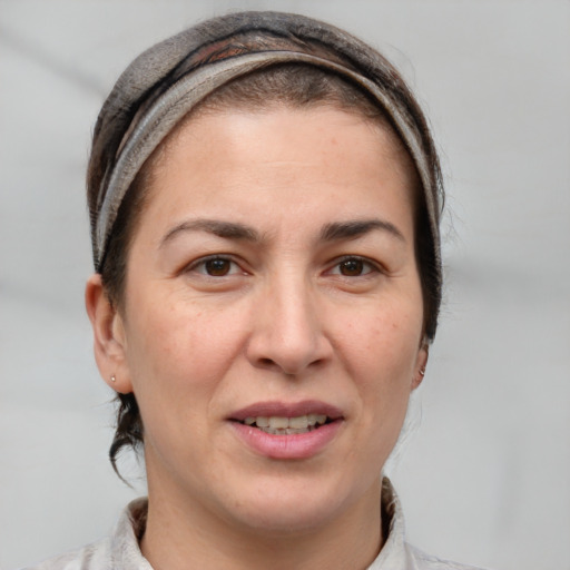 Joyful white adult female with short  brown hair and grey eyes