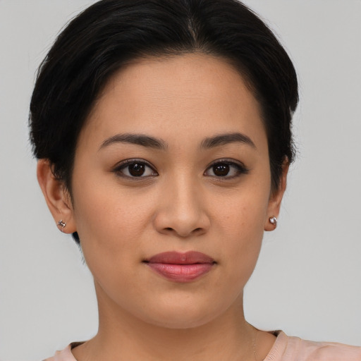 Joyful latino young-adult female with short  brown hair and brown eyes