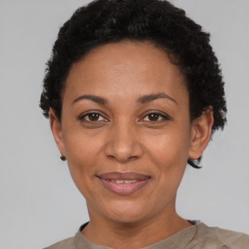 Joyful latino adult female with short  black hair and brown eyes