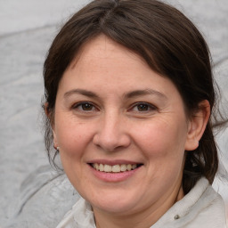 Joyful white adult female with medium  brown hair and brown eyes