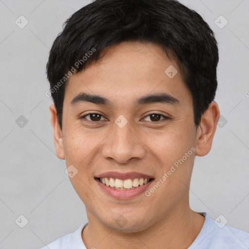 Joyful latino young-adult male with short  black hair and brown eyes