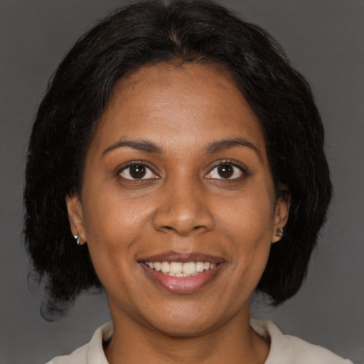 Joyful black young-adult female with medium  brown hair and brown eyes