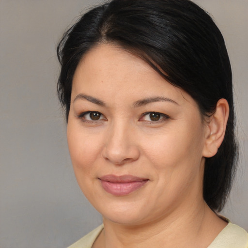 Joyful asian adult female with medium  brown hair and brown eyes