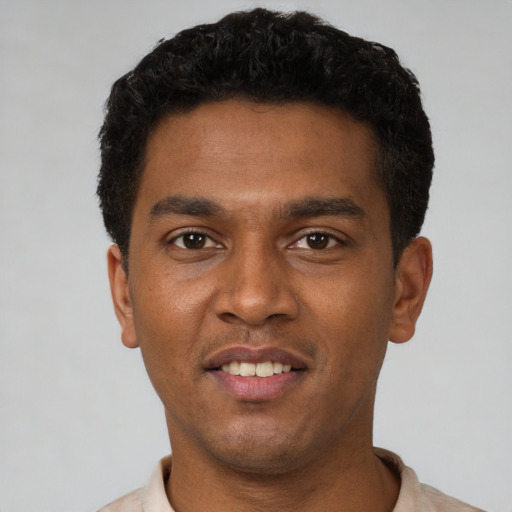 Joyful latino young-adult male with short  brown hair and brown eyes