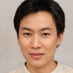 Joyful asian young-adult male with short  brown hair and brown eyes