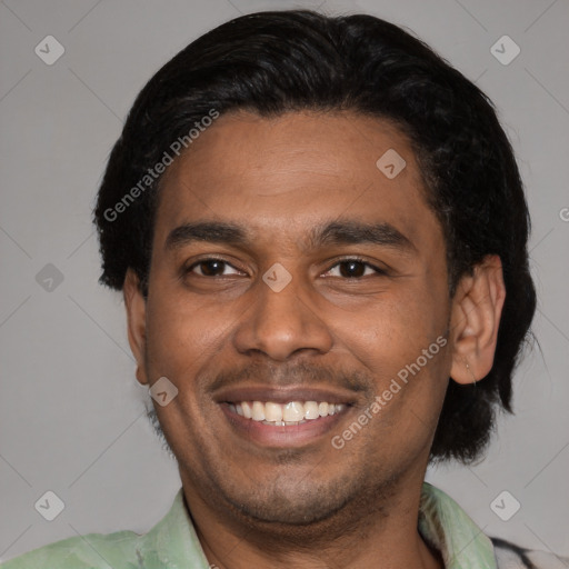 Joyful latino adult male with short  black hair and brown eyes