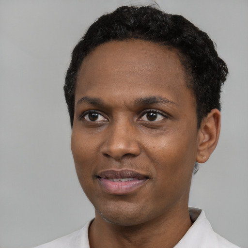 Joyful black young-adult male with short  black hair and brown eyes