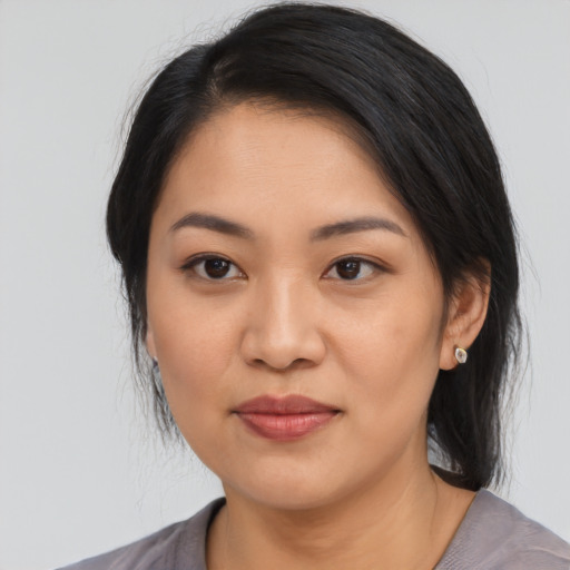 Joyful asian young-adult female with medium  black hair and brown eyes