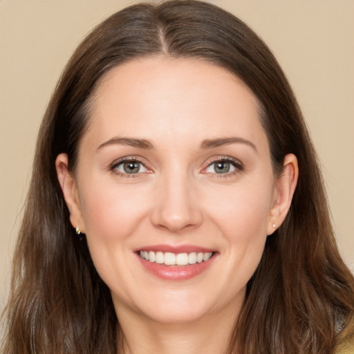 Joyful white young-adult female with long  brown hair and brown eyes