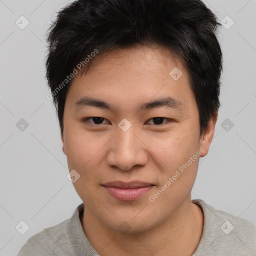 Joyful asian young-adult male with short  brown hair and brown eyes