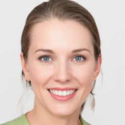 Joyful white young-adult female with medium  brown hair and blue eyes