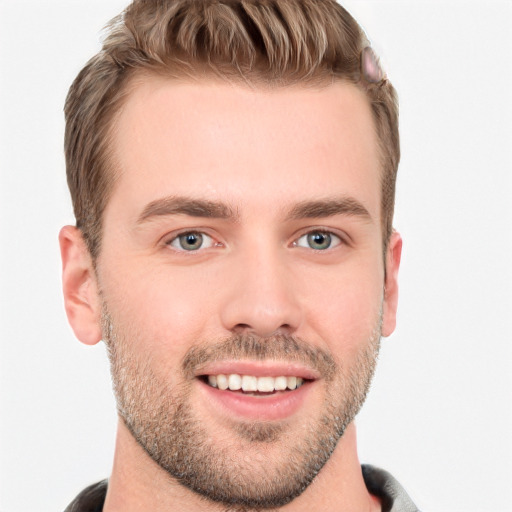 Joyful white young-adult male with short  brown hair and grey eyes