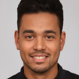 Joyful white young-adult male with short  brown hair and brown eyes