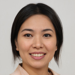 Joyful white young-adult female with medium  brown hair and brown eyes