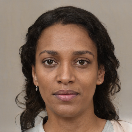 Neutral black young-adult female with medium  brown hair and brown eyes