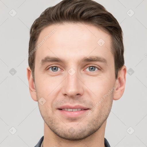 Joyful white young-adult male with short  brown hair and grey eyes