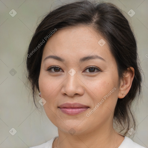 Joyful asian adult female with medium  brown hair and brown eyes