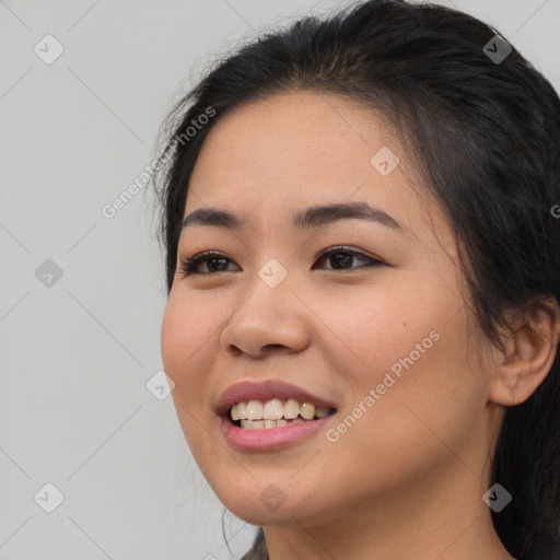 Joyful asian young-adult female with long  brown hair and brown eyes