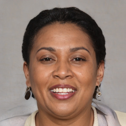 Joyful latino adult female with short  brown hair and brown eyes