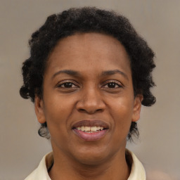 Joyful black adult female with short  brown hair and brown eyes