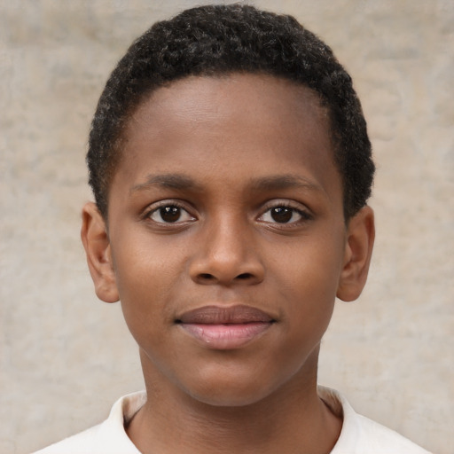 Joyful black child male with short  brown hair and brown eyes