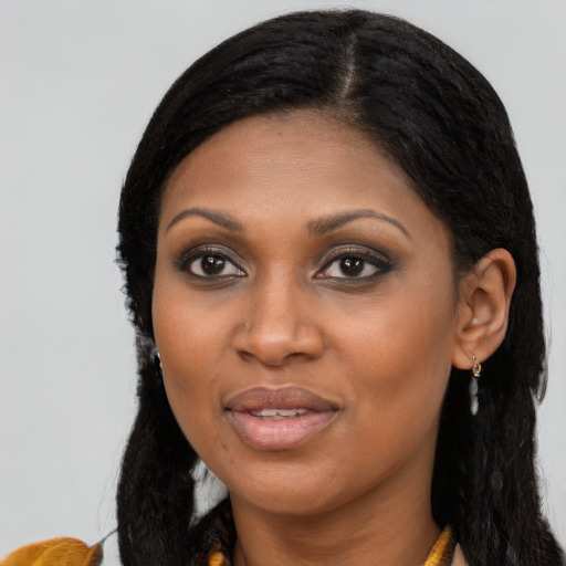 Joyful black young-adult female with long  black hair and brown eyes