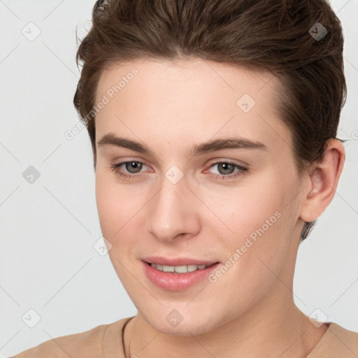 Joyful white young-adult female with short  brown hair and brown eyes