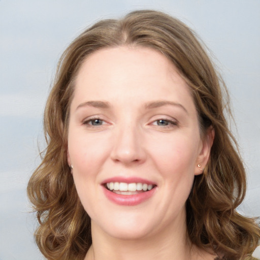 Joyful white young-adult female with medium  brown hair and blue eyes